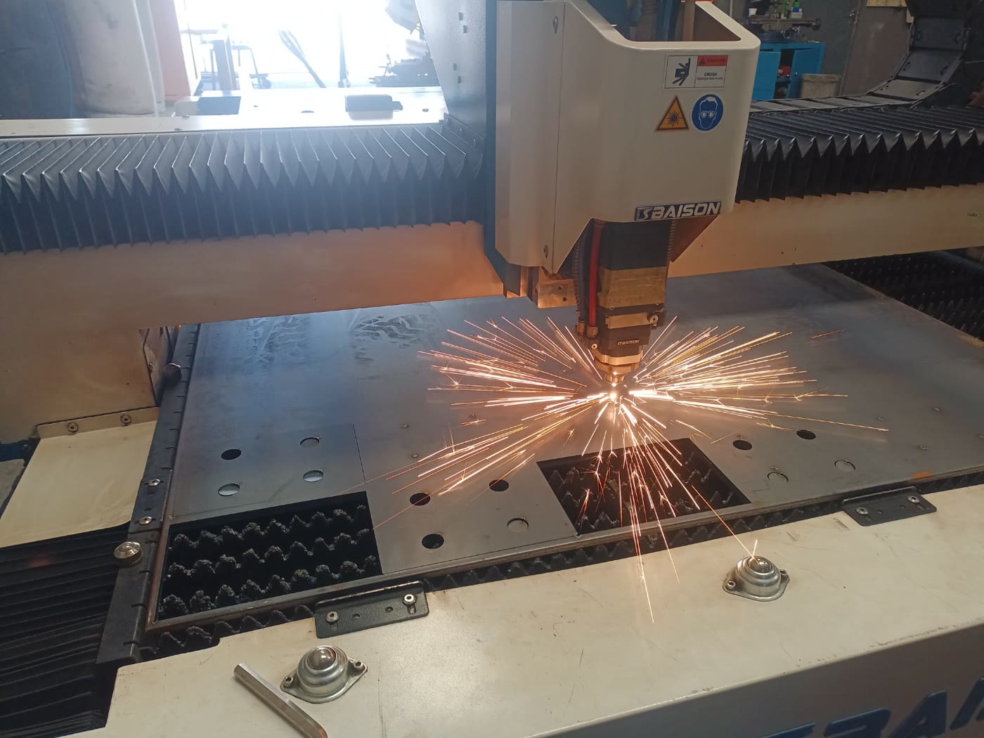Close-up of fiber laser cutting through sheet metal